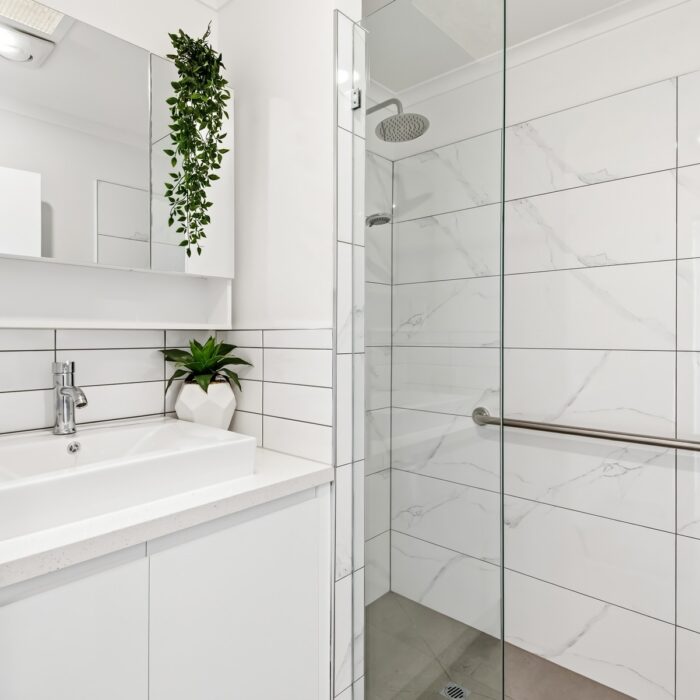 Renovated bathroom with walk-in shower in Unit 23